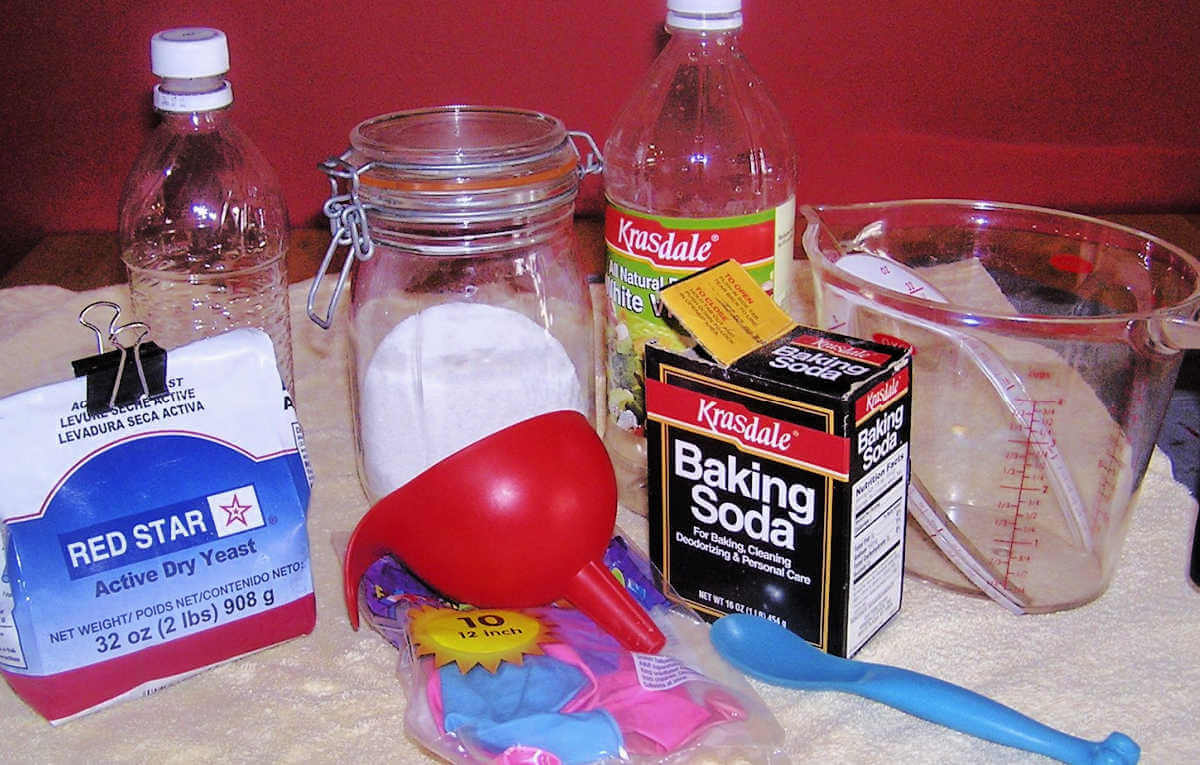 Supplies for balloon science experiments laid out on towel