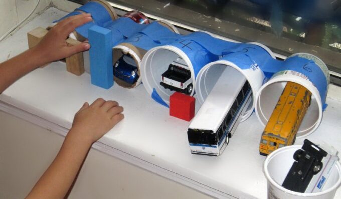 Containers taped together to make toy parking garage