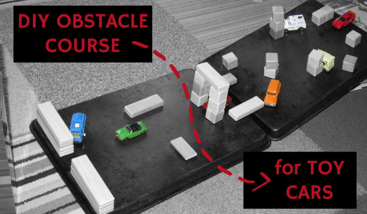 Toy blocks and cars on a diy obstacle course made from baking sheets