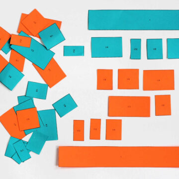 Blue and orange paper cut into fraction sizes.