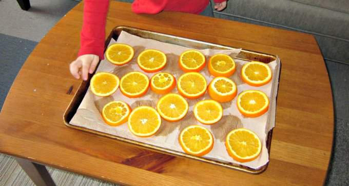 Orange slices to dry as an indoor nature activity for kids in winter.